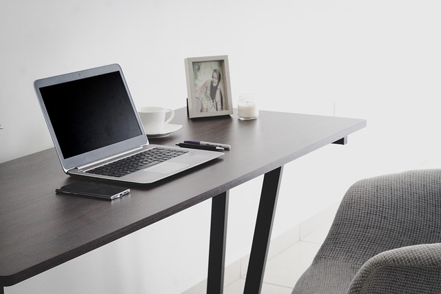 focused european professional deep work on laptop dark minimalist desk