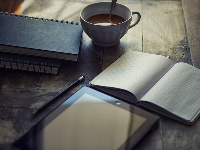 minimal modern workspace with journal coffee and warm gold light